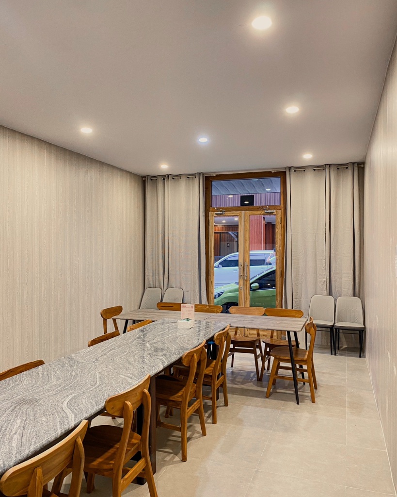 Lyon's Cafe meeting room interior with wooden chairs and curtained walls